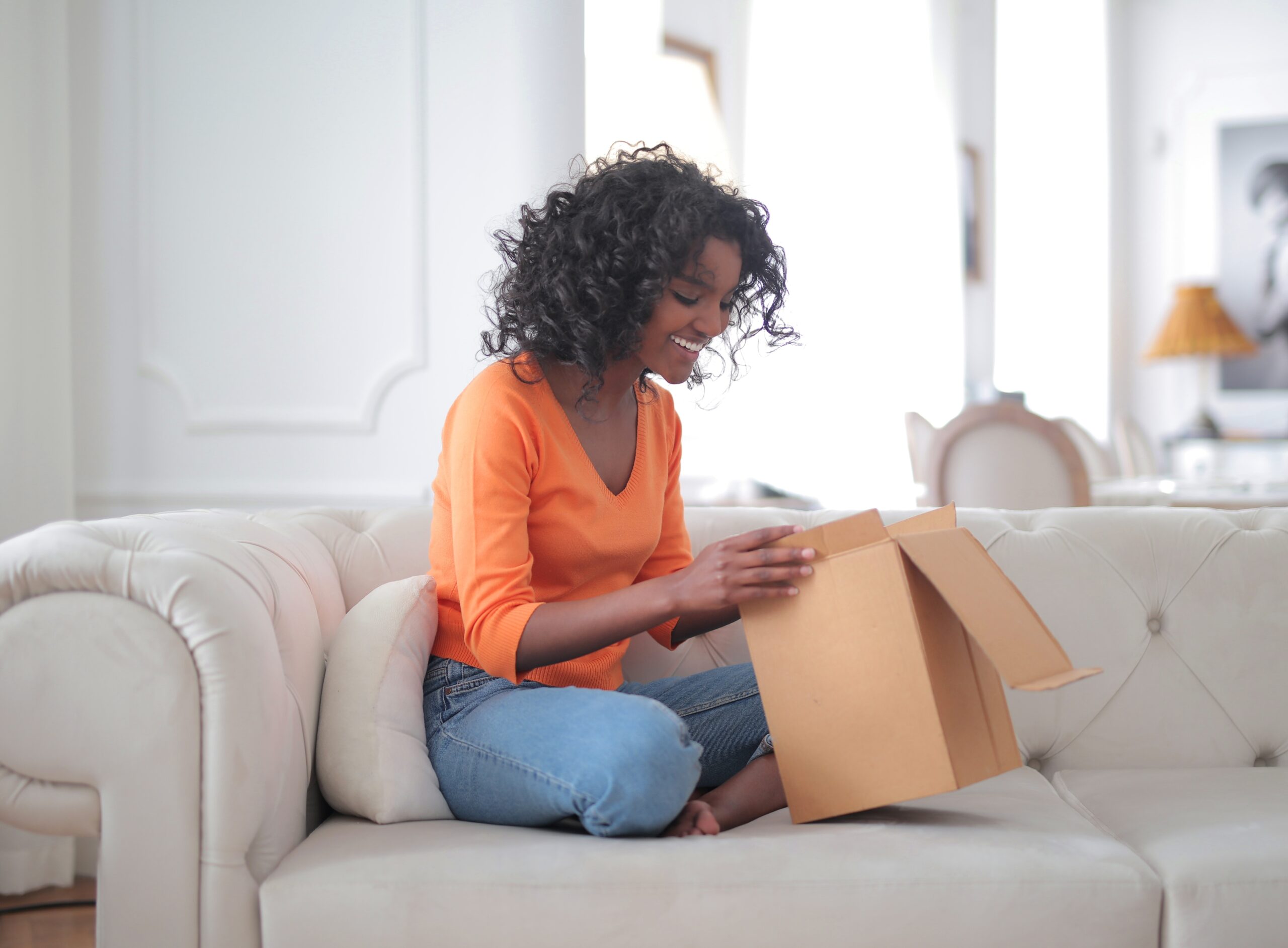 Woman excitedly opening a delivered package