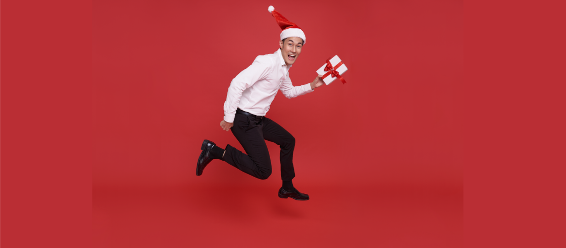 jumping-asian-businessman-wearing-santa-hat-and-ho-2022-10-20-01-45-31-utc